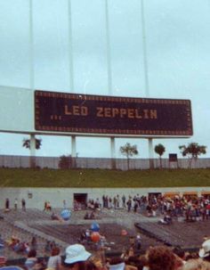 a large sign that reads led zeppelinn in front of a stadium full of people