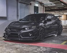 a black car parked in a parking garage