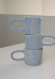 three blue and white cups stacked on top of each other