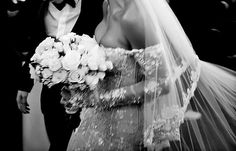 the bride and groom are walking down the aisle at their wedding ceremony in black and white