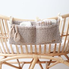 a baby crib with two blankets on top of it and a pillow in the middle