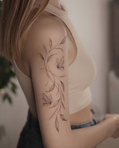 a woman with a flower tattoo on her arm