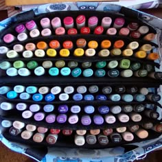 a bunch of different colored crayons are stacked on top of eachother