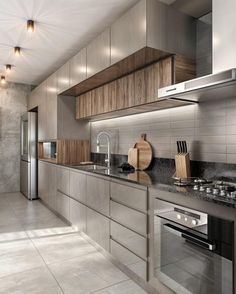 a modern kitchen with stainless steel appliances and wood cabinets