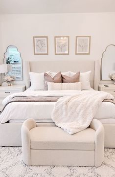 a white bed sitting in a bedroom on top of a rug