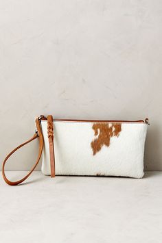 Silky hair-on cowhide lends rustic elegance to this beautiful and practical accessory. This wristlet coverts to a shoulder bag, thanks to adjustable strap clips, and features a main compartment with inner zip pocket to stash your essentials. The cowhide's natural markings are unique to each piece. Fur Accessories, Branded Wallets, Silky Hair, Womens Purses, Odessa, Rustic Elegance, Leather Bags