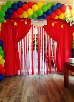 a room decorated with balloons and streamers