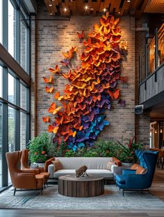 a living room filled with lots of furniture next to a wall covered in paper butterflies