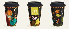 three travel mugs with different designs on them, one for mcdonald's and the other for mcdonald's