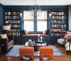 a living room filled with furniture and bookshelves covered in lots of bookcases