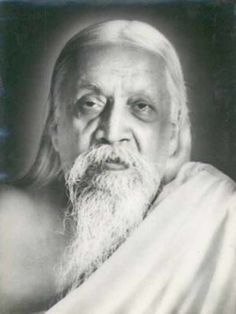 an old photo of a man with long white hair and beard wearing a white robe