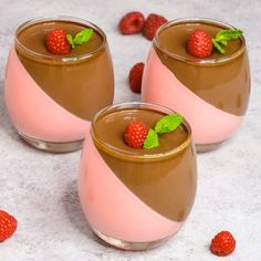 three glasses filled with chocolate pudding and raspberries