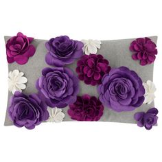 a decorative pillow with purple and white flowers on it