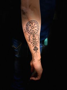 a person with a compass tattoo on their arm