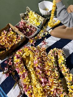 flowers are laid out on a checkered tablecloth with bowls and spoons in the background