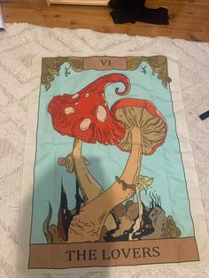 an image of a red mushroom on the cover of a tarp with words that read, the lovers