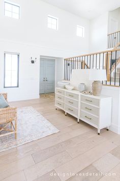 a living room filled with furniture and a stair case in the middle of it's floor