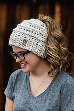 a woman wearing glasses and a knitted headband