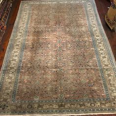 an antique rug is on the floor in a room