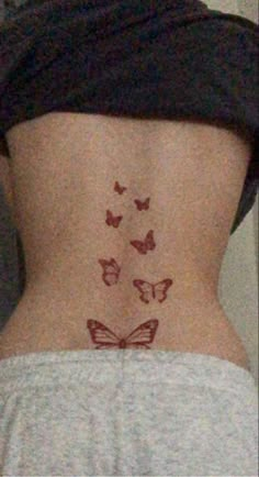 the back of a woman's stomach with butterflies drawn on her lower body and side