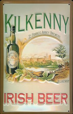 a sign for kilkenny irish beer hangs on the wall