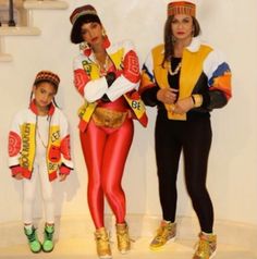 two women and a child are dressed up in costumes that look like they're from the 80s