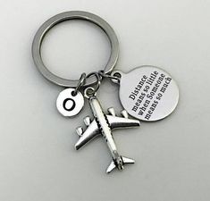 a keychain with an airplane charm attached to it