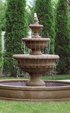 a water fountain in the middle of a garden