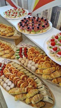 a table topped with lots of different types of pastries and desserts next to each other