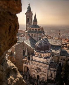 an aerial view of a large building in the middle of a city with many spires