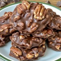 chocolate pecan cookies stacked on top of each other with walnuts in the middle