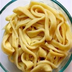 a glass bowl filled with uncooked noodles