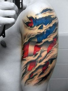 a man's arm with an american flag tattoo on it, holding a cell phone