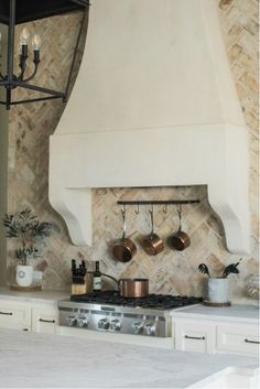 a kitchen with an oven, stove and counter tops in it's center island