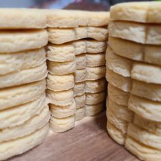 several stacks of pancakes sitting on top of a wooden cutting board next to each other