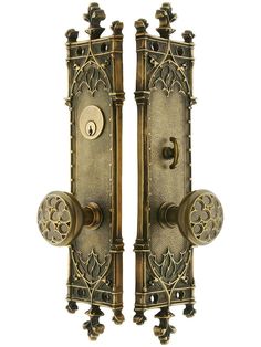 two antique style door handles with decorative knobs