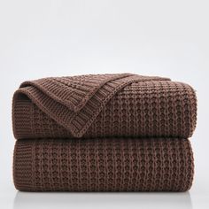 two brown knitted blankets folded on top of each other