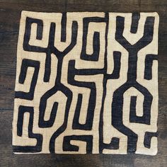 a black and white rug on top of a wooden floor