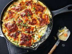 a skillet filled with lasagna covered in sauce