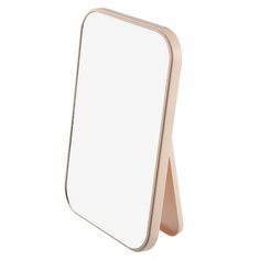 a white mirror sitting on top of a wooden stand