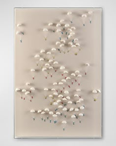 an art work with white umbrellas and stars on the bottom, in front of a beige background