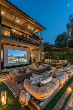 an outdoor movie room with couches and lights