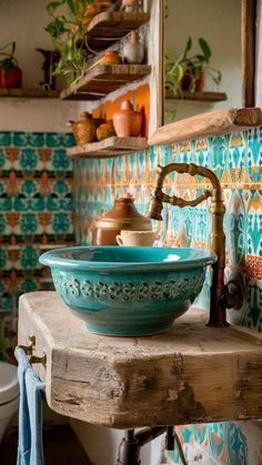 a bowl sink sitting on top of a wooden table next to a toilet and wall