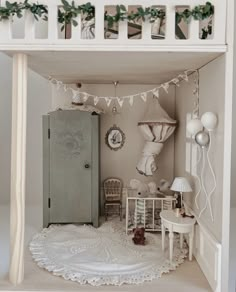 a doll house with white furniture and decorations