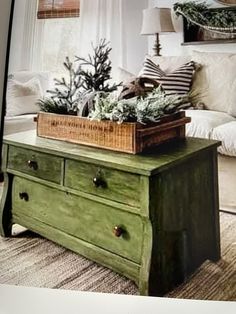 a living room filled with furniture and a christmas tree on top of a coffee table