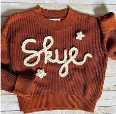 These custom embroidered sweaters are high quality, super soft and 100% cotton and the customization are hand embroidered with yarn of your color choice. Sweater Color Choices: Brown White Personalization: please provide all necessary personalized information in as much detail as possible.  Please specify cursive or block for letters as well as capitalization. Its a perfect gift for a birthday, newborn gift, thanksgiving,  valentine's day, christmas or just because. Please do not hesitate to message us for any additional personalization or any custom that you have. Custom Baby Gift, Baby Christmas Gift, Custom Baby Gifts, Baby Christmas Gifts, Baby Christmas