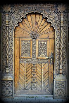 an old wooden door with intricate carvings on it