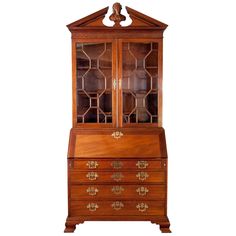 an old wooden china cabinet with glass doors and drawers on the front, against a white background