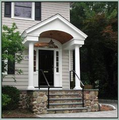 a house with stone steps leading up to the front door