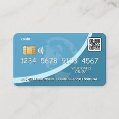 a credit card sitting on top of a white marble counter with a qr code